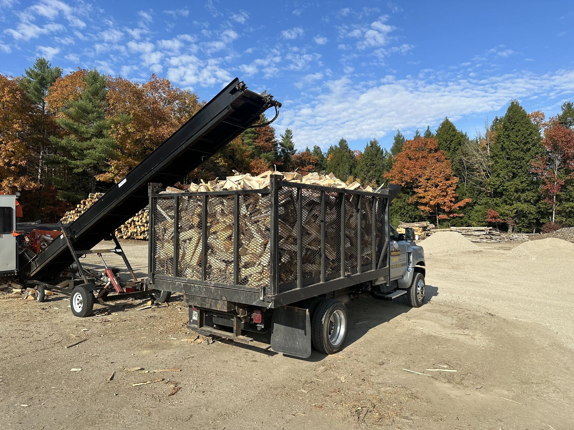 A truck loaded with split firewood, ready for delivery